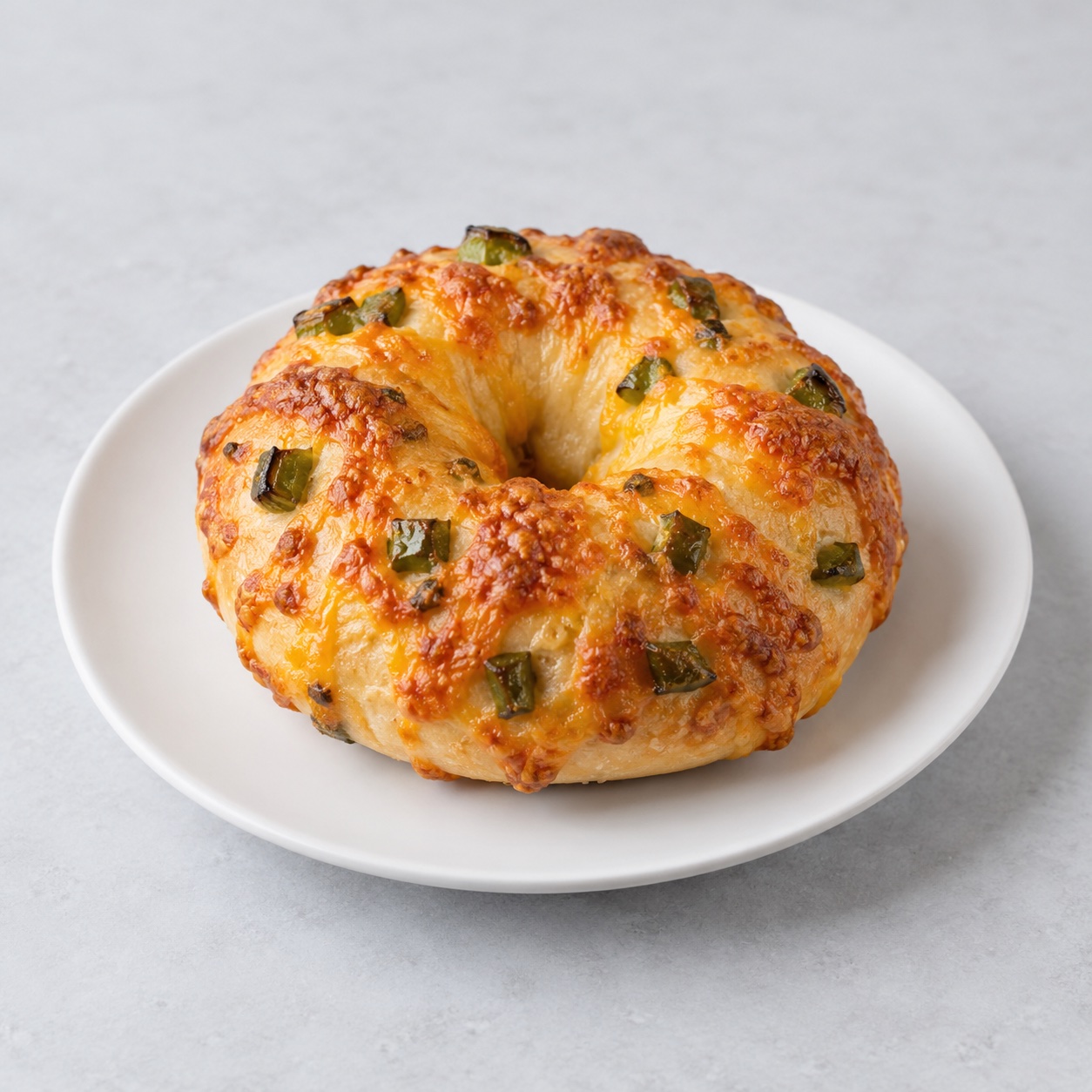 Illustrative Jalapeño Cheddar Protein Bagel — approved menu image